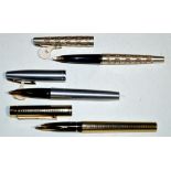 Three Sheaffer fountain pens, one in silver plated case with gold coloured wave design,