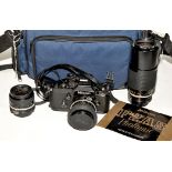 A Nikon F2 AS SLR camera (black); with Nikkor lenses-- 50mm f1.8, 28mm f3.5, and 80-200mm f4.