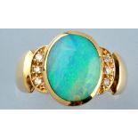 An opal and diamond ring, the oval opal cabouchon in collet setting,