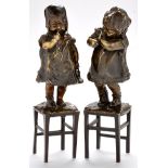 Juan Clara (Spanish 1875-1958): a pair of brown patinated bronze models of children standing on