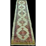 A Sarab runner, with five diamond medallions on cream coloured ground, 510 x 112cms (200 1/2 x 44in.