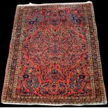 A Sarouk rug, with floral scrolls on red ground, 150 x 106cms (59 x 41 1/2in.).