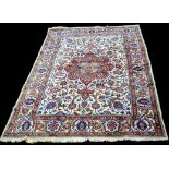 An Isfahan carpet, the central rosette on ivory field with scrolling design,