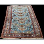 A Caucasian carpet, with medallions on light blue ground, 256 x 169cms (100 1/2 x 66 1/2in.).