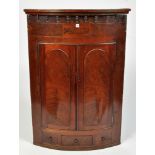 A George III mahogany bowfront hanging corner cabinet,