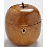 An apple pattern fruitwood tea caddy, with shield-shaped escutcheon, 5in. (12cms) high.