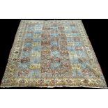 A Moud carpet, the field with panels of floral designs, 314 x 233cms (123 x 91 1/2in.).