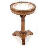 A William IV walnut jardiniere stand, the circular top with pierced brass gallery,