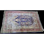 A Sarough rug, the oval field with vase of flower design, 160 x 108cms (63 x 42 1/2in.).