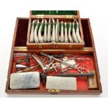 An early 20th Century surgeon's set of instruments, in lacquered brass-bound mahogany case,