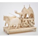 Carved 19th Century Indian ivory model of a wagon drawn by two oxen, with two passengers and driver,