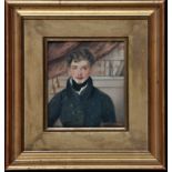 19th Century British School A half-length portrait of a young man posing by a bookcase, watercolour,