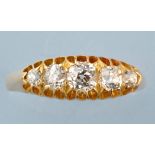 A five stone diamond ring, the graduated old cut diamonds on yellow metal shank, ring size R.