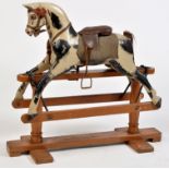 Line Brothers, Tri-ang: a piebald rocking horse on painted wooden stand, some losses and damages,
