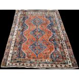 A Qashqai carpet, with triple medallion to floral field, 296 x 222cms (116 1/2 x 87 1/2in.).