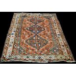 A Qashqai carpet, the triple medallion on floral ground, 295 x 205cms (116 x 80 1/2in.).