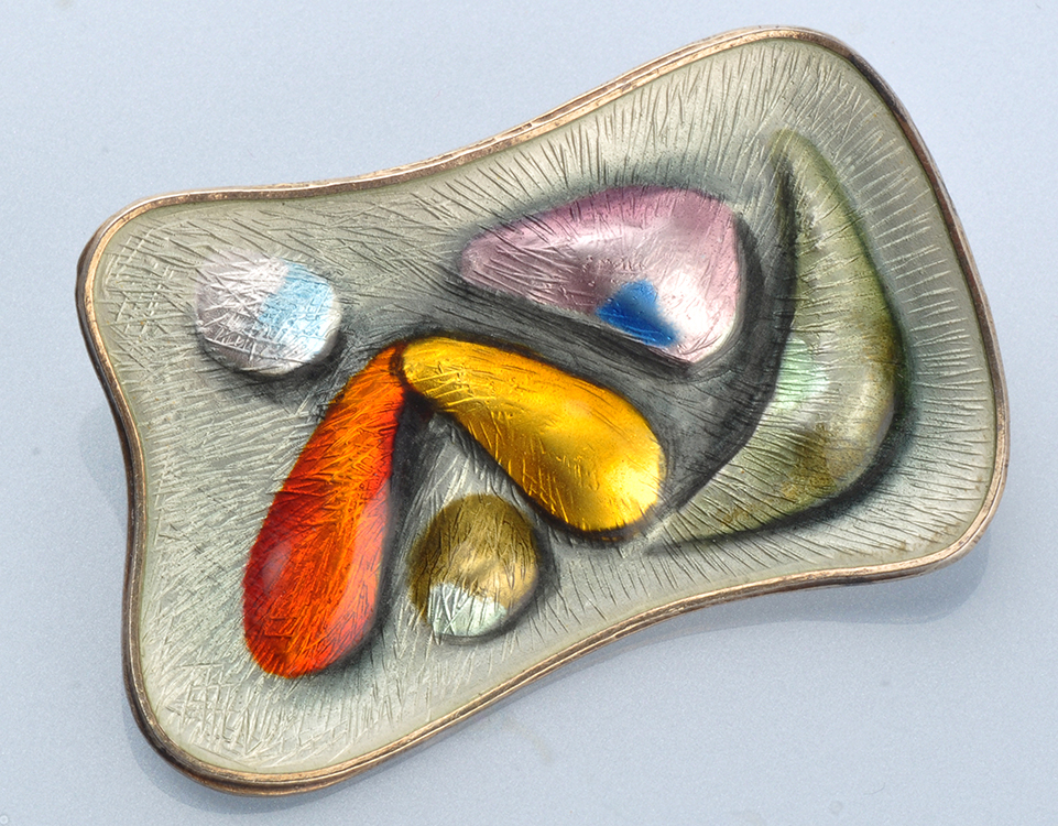 Oystein Balle, Norway: a shaped rectangular silver gilt and polychrome enamel brooch, 5.7 x 3cms.