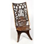 A 20th Century African carved hardwood fertility chair,