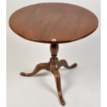 An early 19th Century oak tip-up-top table,