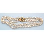 A cultured pearl triple row necklace, the uniform pearls each 6.