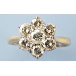A diamond cluster ring, set with seven brilliant cut diamonds in white metal, on 18ct.