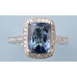 A tanzanite and diamond cluster ring, the oval fancy cut tanzanite corner set,