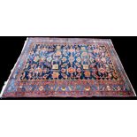 A Malayer rug, the blue ground decorated with geometric motifs, 194 x 153cms (76 x 60in.).