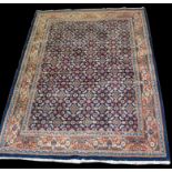 A Kerman carpet, with flowerhead motifs to blue field, 241 x 175cms (95 x 69in.).