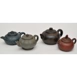 Four Yixing stoneware teapots and covers, of flattened circular and pumpkin shape,