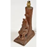 Thomas "Gnomeman" Whittaker: a carved oak table lamp decorated with a gnome leaning against a tree,