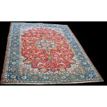 An Isfahan carpet, with central rosette medallion surrounded by scrolling floral decoration,