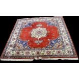 A Tabriz carpet, the central rosette within open red field, 310 x 300cms (122 x 118in.).