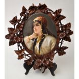 Large framed oval Continental porcelain panel, depicting young gypsy girl in three-quarter profile,