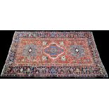 A Heriz rug, decorated with geometric floral design, 188 x 145cms (74 x 57in.).