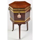 A George III hexagonal brass bound mahogany wine cooler, with ebony stringing,
