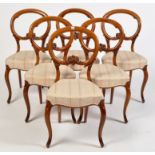 A set of six Victorian walnut balloon back dining chairs,