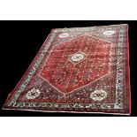 An Abadeh carpet, with flowerheads to red ground, 311 x 206cms (122 1/2 x 81in.).