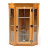 Carpenter unknown: an oak corner hanging display cabinet with leaded glass panels,