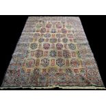 A Kerman carpet, with floral panels to field, 383 x 260cms (150 1/2 x 102in.).