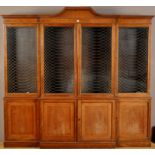 An Edwardian mahogany breakfront bookcase, decorated with boxwood stringing,