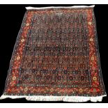 A Hamadan rug, with small flowerhead design, 202 x 139cms (79 1/2 x 54 1/2in.).