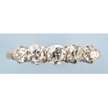 A five stone diamond ring, the old cut graduated diamonds in white metal crown mounts,