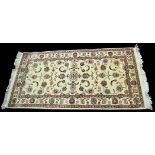 A Tabriz rug, with scrolling floral design on ivory ground, 142 x 71cms (56 x 28in.).