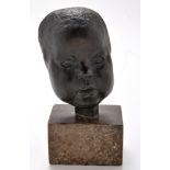 Manner of Jacob Epstein: a green/brown patinated bronze mask of a baby, on stone plinth, 27cms,