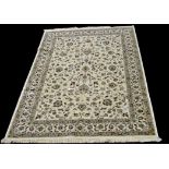 A Kashmir carpet, the scrolling floral design on ivory ground, 304 x 196cms (19 1/2 x 77in.).