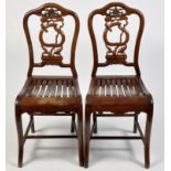 A pair of carved Chinese hardwood chairs,