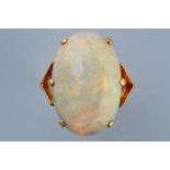 An opal ring, the oval opal cabouchon in six claw setting, on yellow metal shank stamped '18ct.