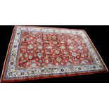 A Sarough carpet, the red ground decorated with scrolling floral design,