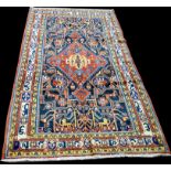 A Persian rug, of geometric design with flowers and animals, 354 x 178cms (139 x 70in).