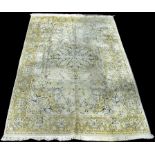 A cashmere carpet, with central floral medallion on light coloured ground, 284 x 181cms (112 x 71in.